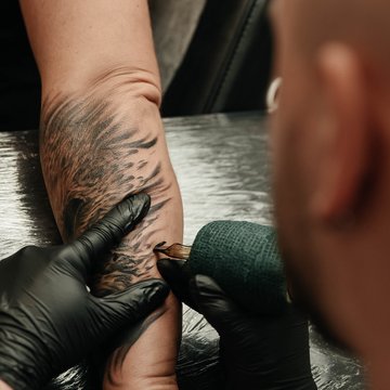 Wykonywanie tatuażu na przedramieniu w VEAN TATTOO