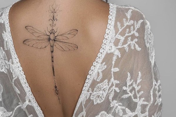 Tatuaż damski z motywem kwiatowym wzdłuż kręgosłupa