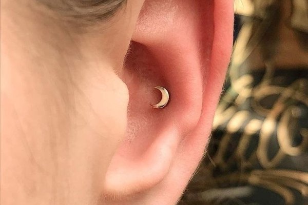 delikatny conch piercing w minimalistycznym stylu