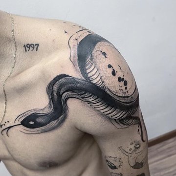 Tatuaż męski na barku  – czarny wąż w stylu graficznym